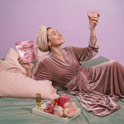 Nestrient GoTwenty Youthful Vitality powdered drink mix in Berry Rose flavor with NAD+, collagen, and CoQ10, displayed in a glass.